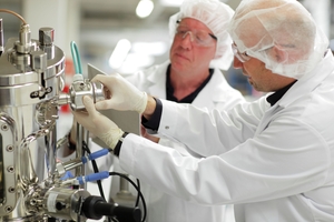 Two employees of a pharma company calibrating measuring equipment