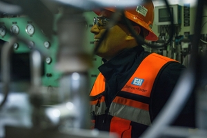 An Endress+Hauser employee with a conductivity analyzer in the background